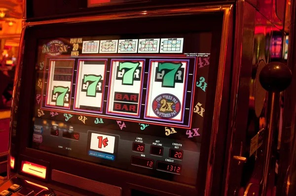 Mobile phone showing Spadegaming slot interface with stake controls and spin button on link latoto
